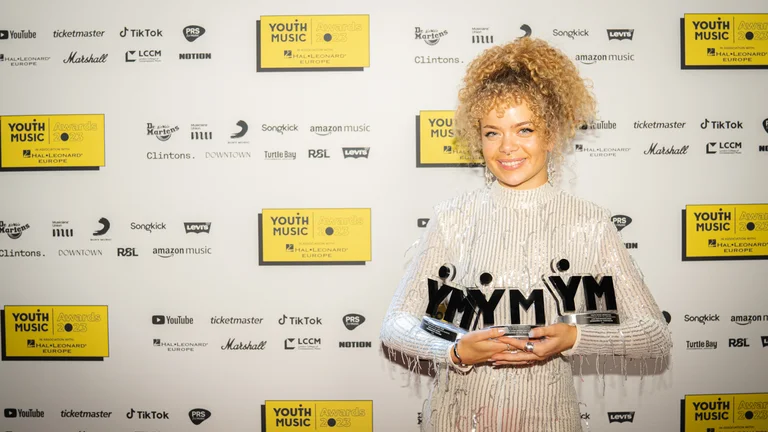 EVA holds her three awards 