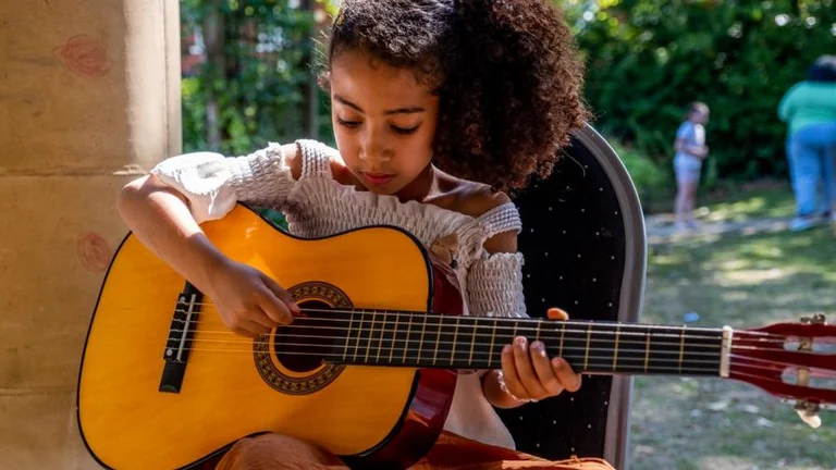 Child playing guitar