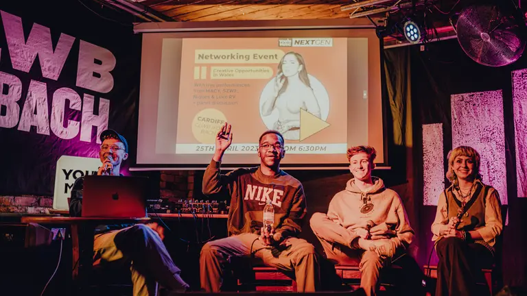 a panel of young creatives sit on stage
