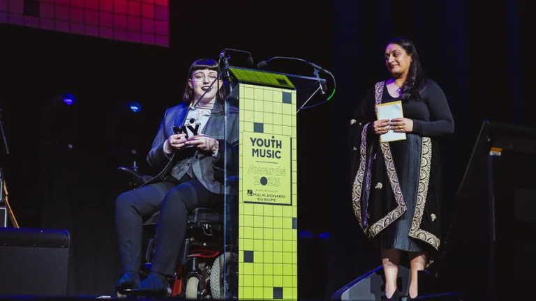 elizabeth j birch accepts her award on stage