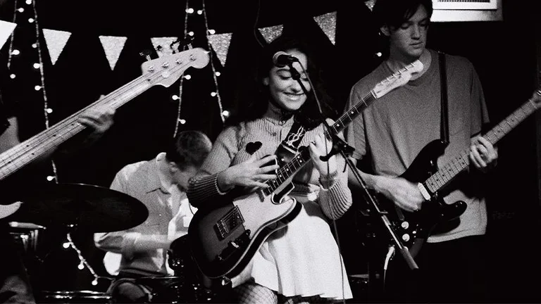 LilY Fontaine playing guitar at a gig