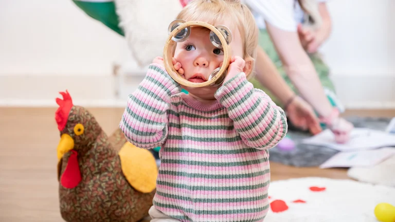 Baby holding a tambourine