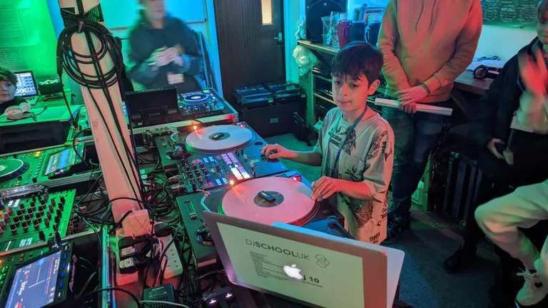 young child learning how to DJ