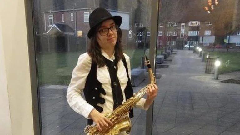 Laura with their saxophone 