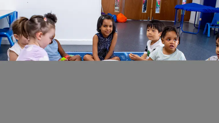 a group of children in a nursery making music