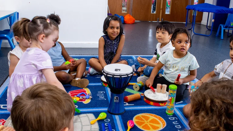 a group of children in a nursery making music