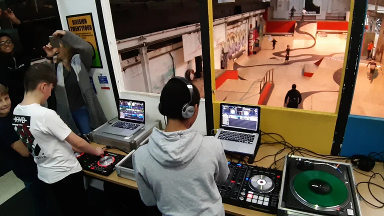 Children at a DJ training session with computers