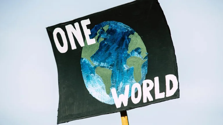 Banner with a picture of Earth that says "one world"