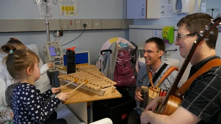 oli and nick with children playing the xylophone and glockenspiel 