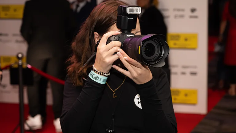  a photographer takes a photo at the youth music awards NextGen photographer Livy Dukes working at the Youth Music Awards 2023 / Credit: Nic Serpell-Rand