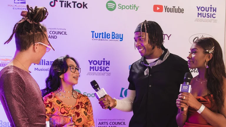 two young presenters interview people at the youth music awards 2021