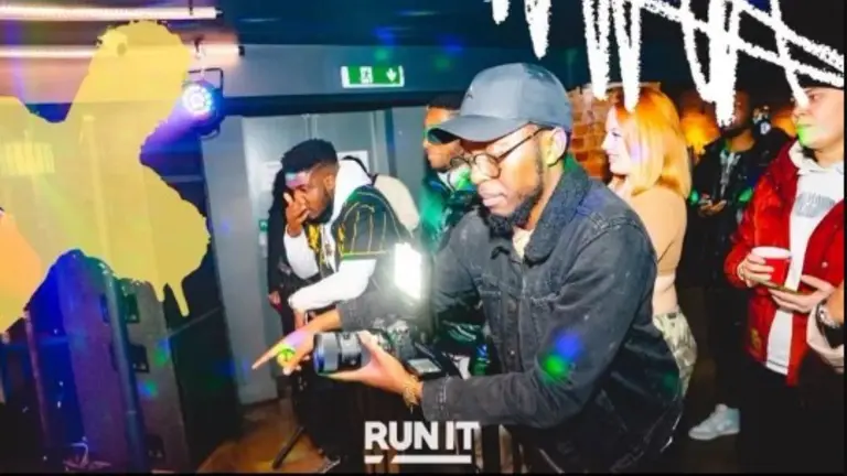 a photographer taking a photo during an event, with his camera flash on.