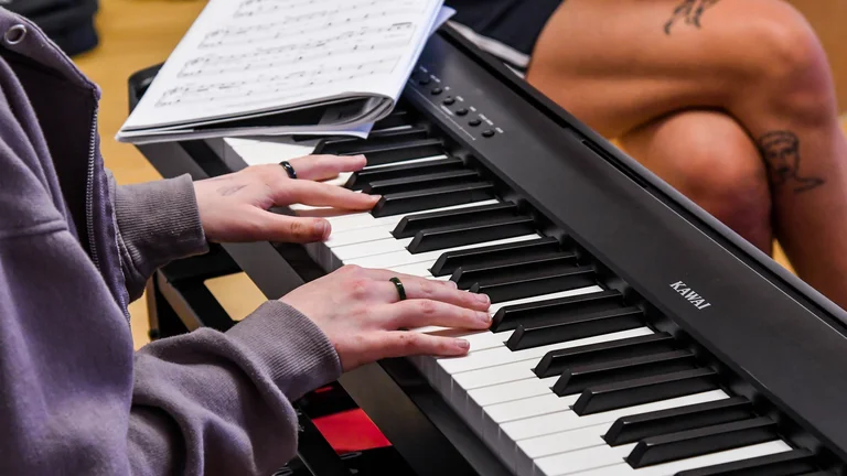 A young person playing piano. 