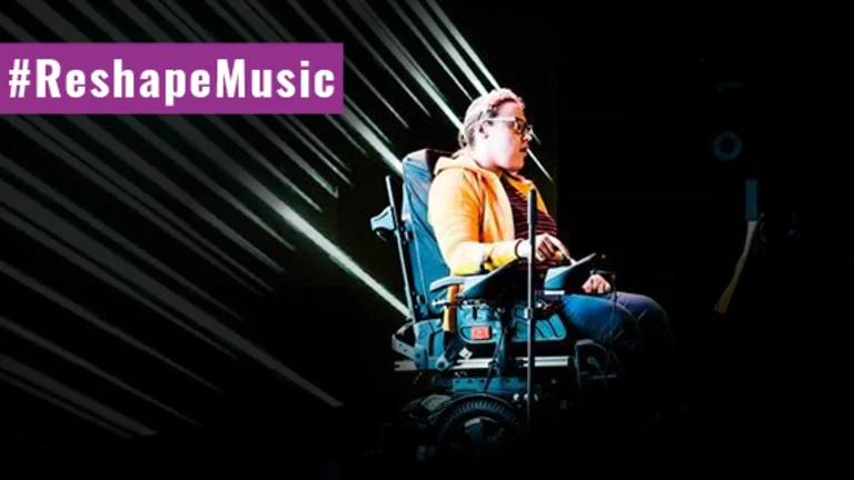 Image of a person in a wheelchair on a dark stage, with #reshapemusic written across in a purple banner