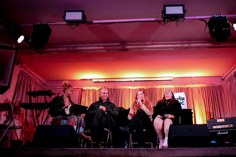 a panel of speakers on stage